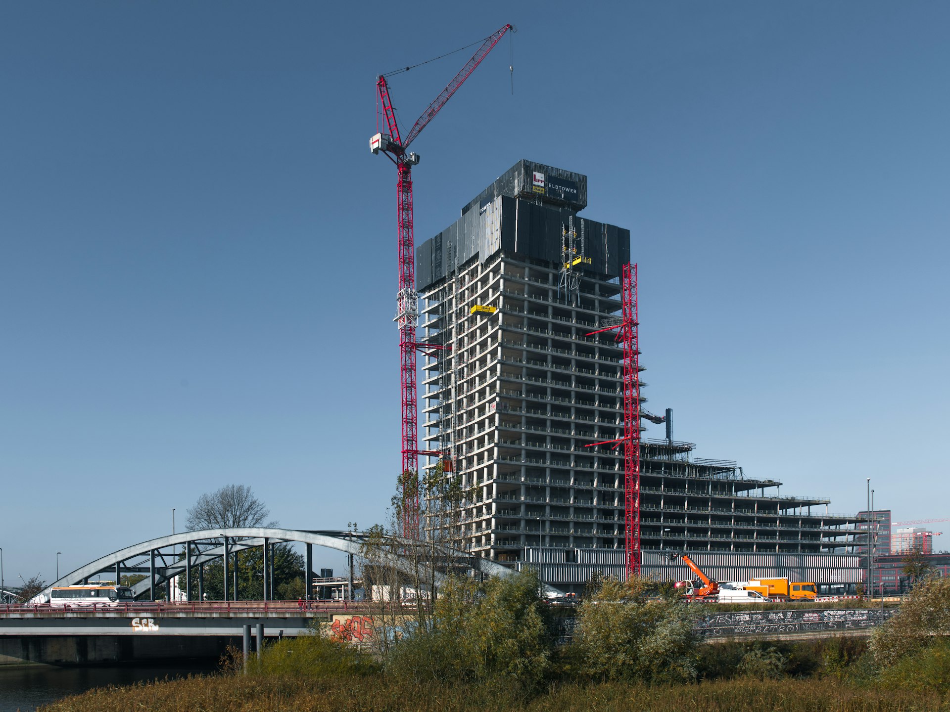 A large building under construction next to a river